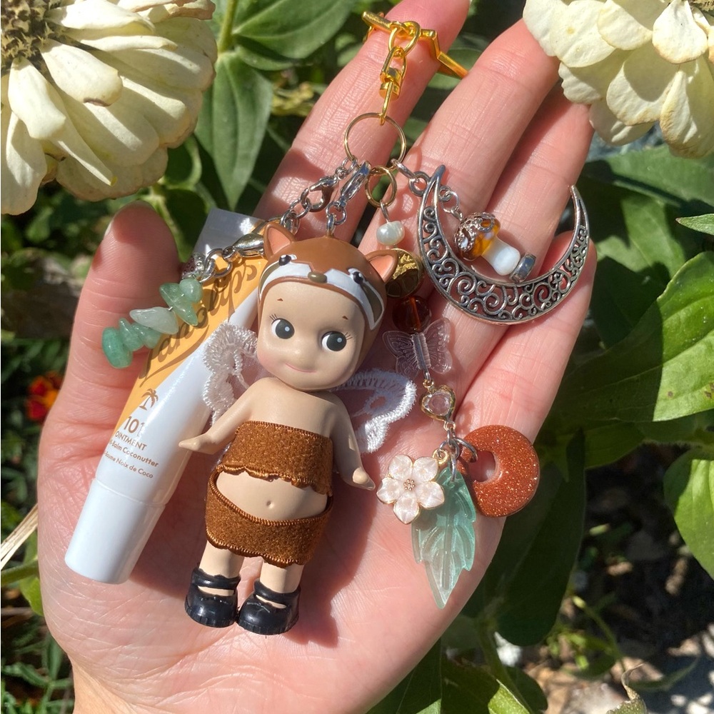 Sonny Angel Keychain / Bag Charm (unrefined lesser panda) with Lanolips lip balm